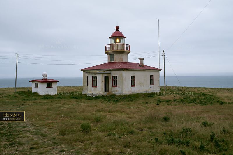 Abandoned lighthouse stands on a remote coastal landscape