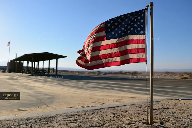 American flag flying in strong wind at outdoor location