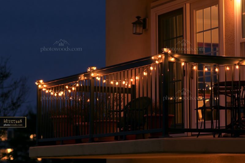 Christmas lights on residential balcony in evening setting