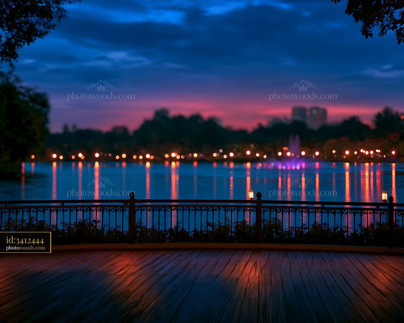 Scenic view of city skyline and lake at dusk
