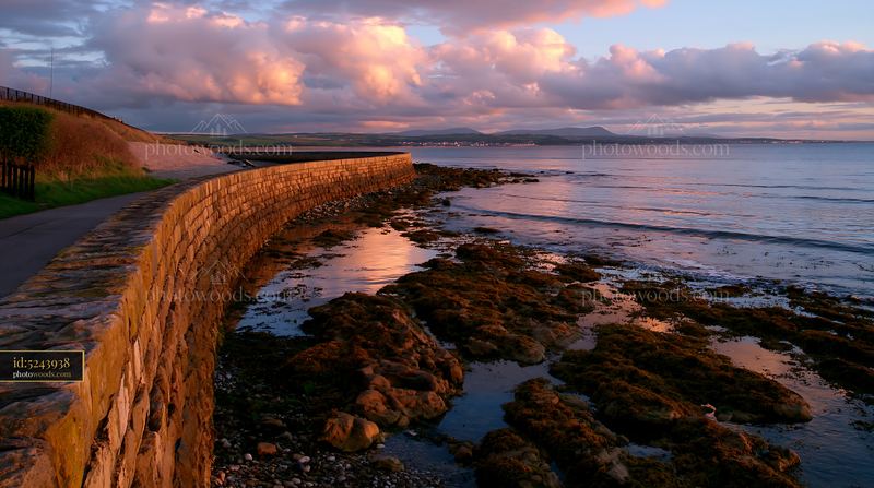 Coastline with protective sea wall at dusk