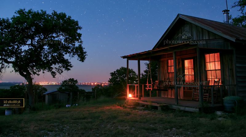 House with swing on porch under starry sky at night