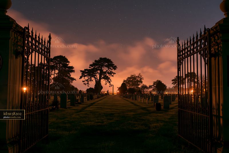 American cemetery under low clouds and stars at night