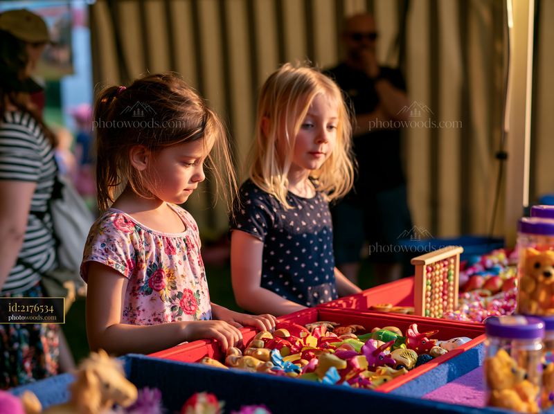 Children choosing prizes at carnival booth