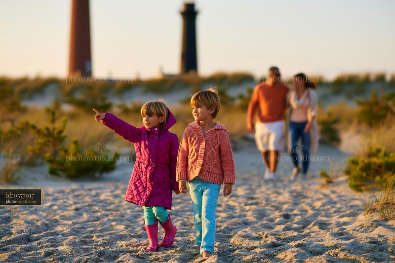 Family at sandy beach near lighthouses enjoying sightseeing