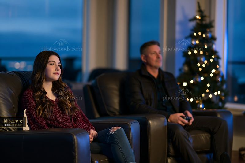 Two people relaxing together in a living room at Christmas