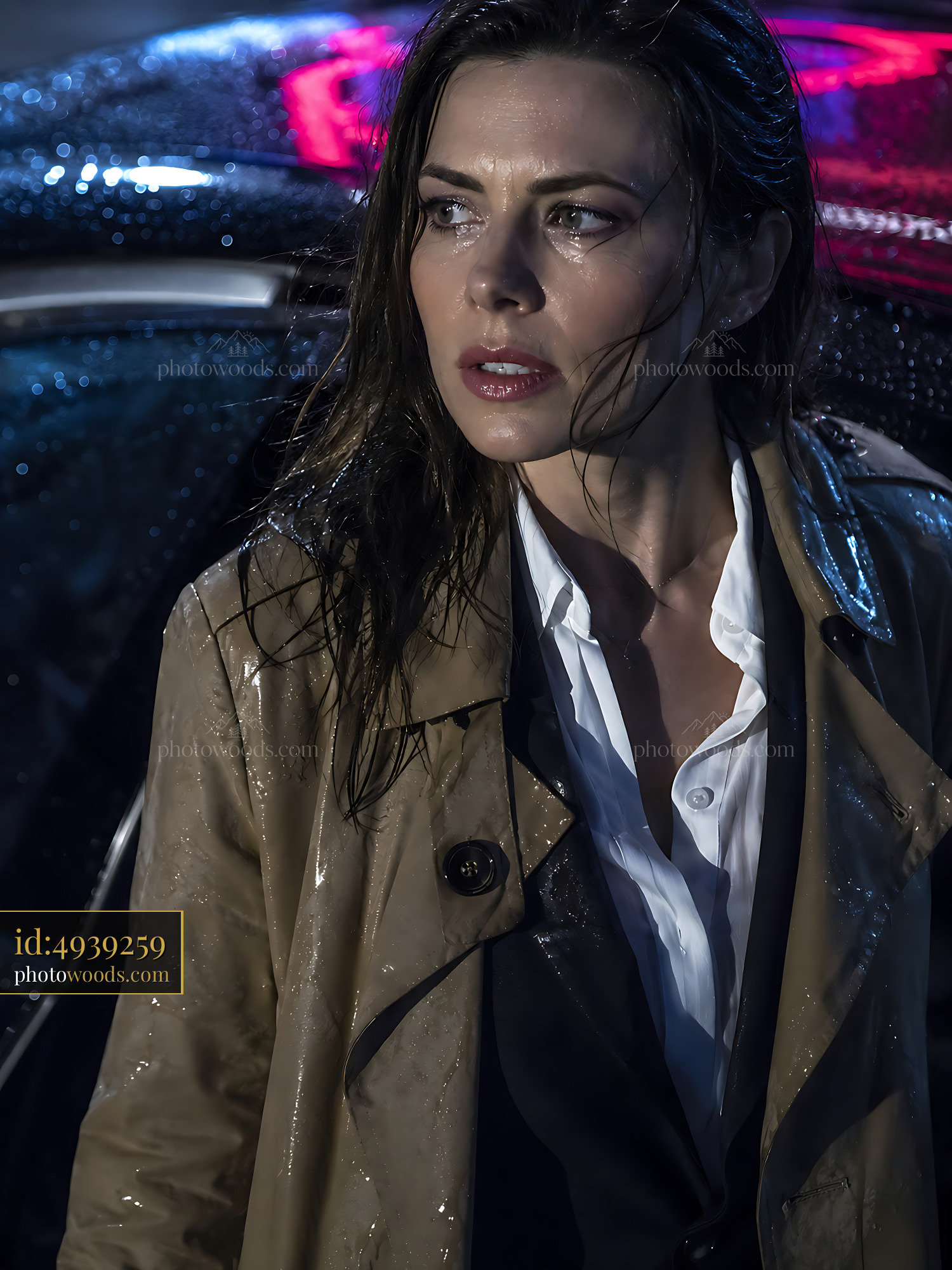 Woman Stands in Rain Near Car Under Neon Lights at Night