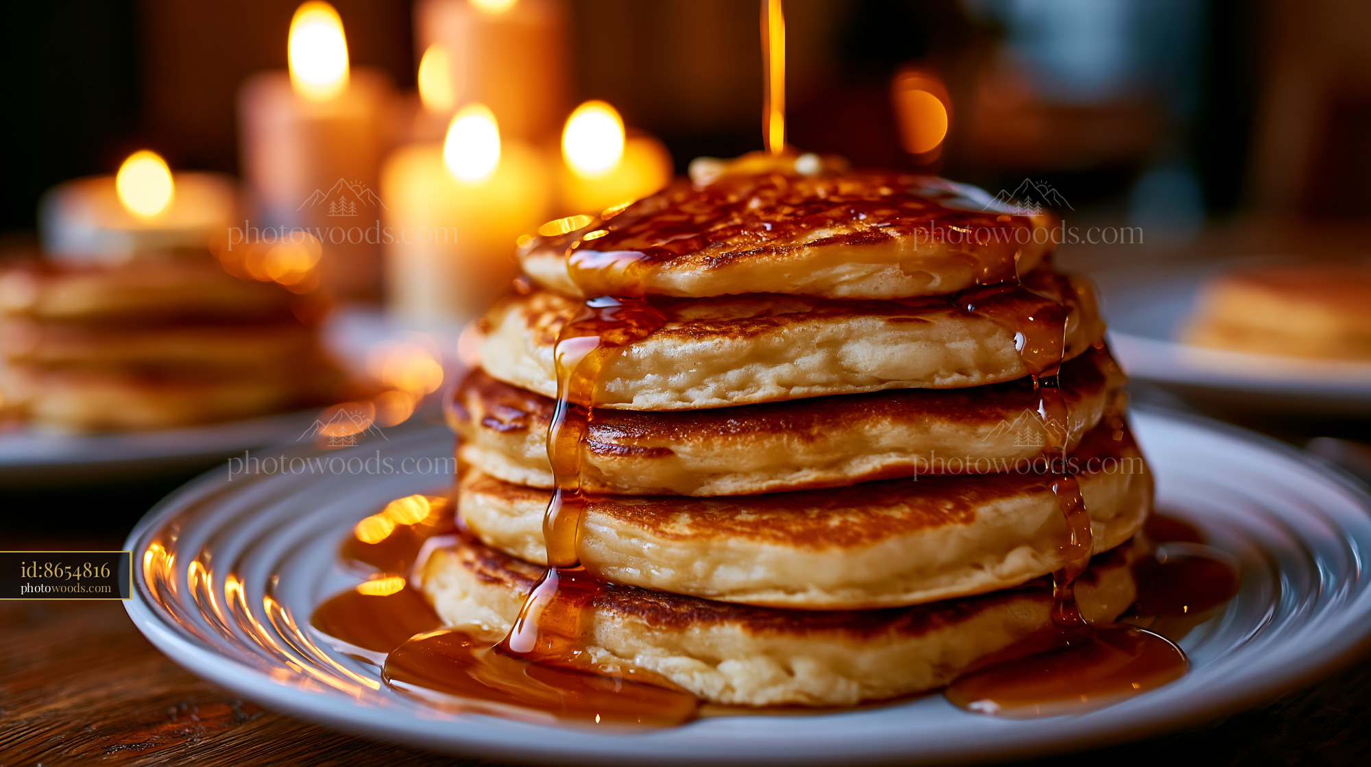 Fluffy Pancakes With Maple Syrup and Candles in Warm Light
