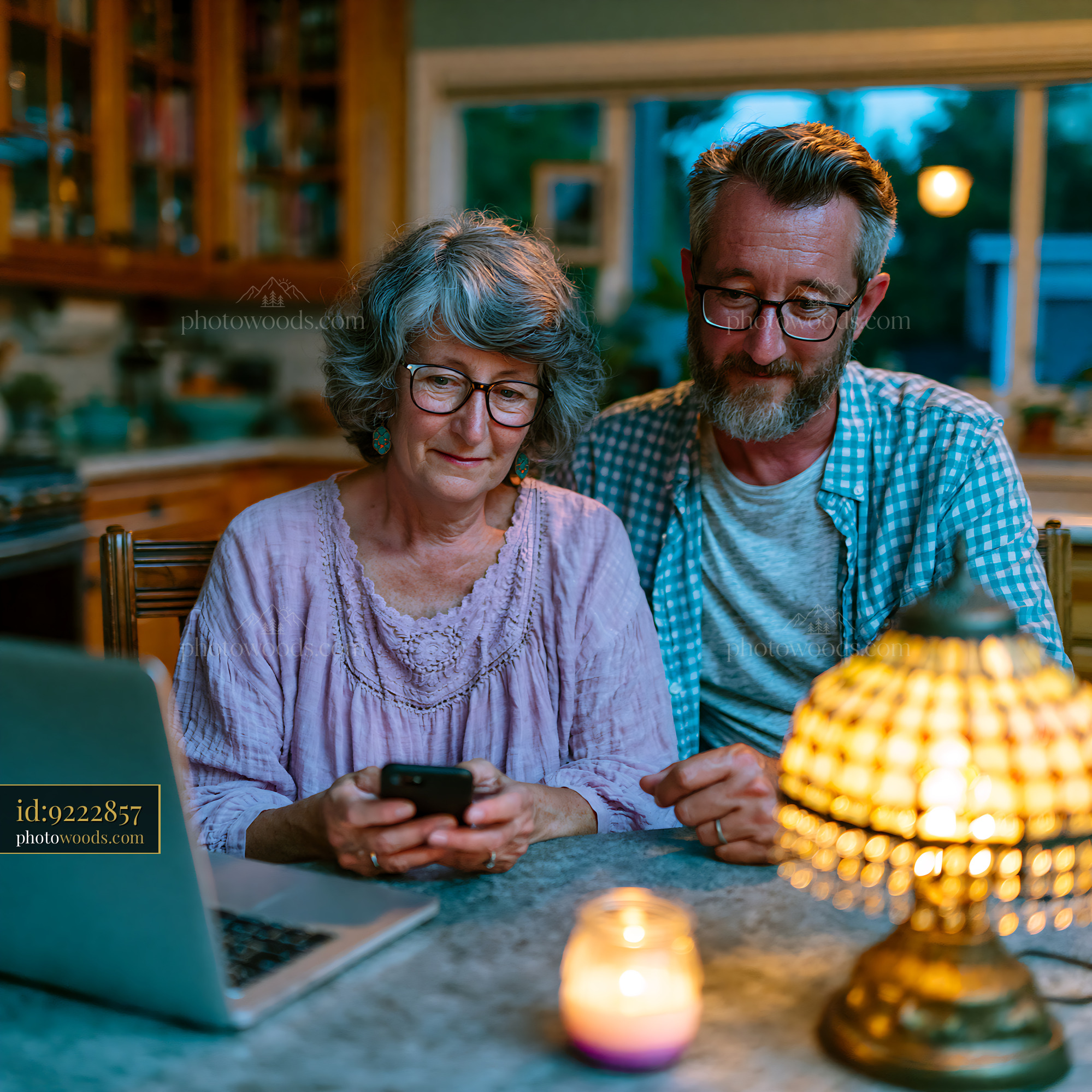 Couple Coordinating Schedule While Using Smartphone and Laptop