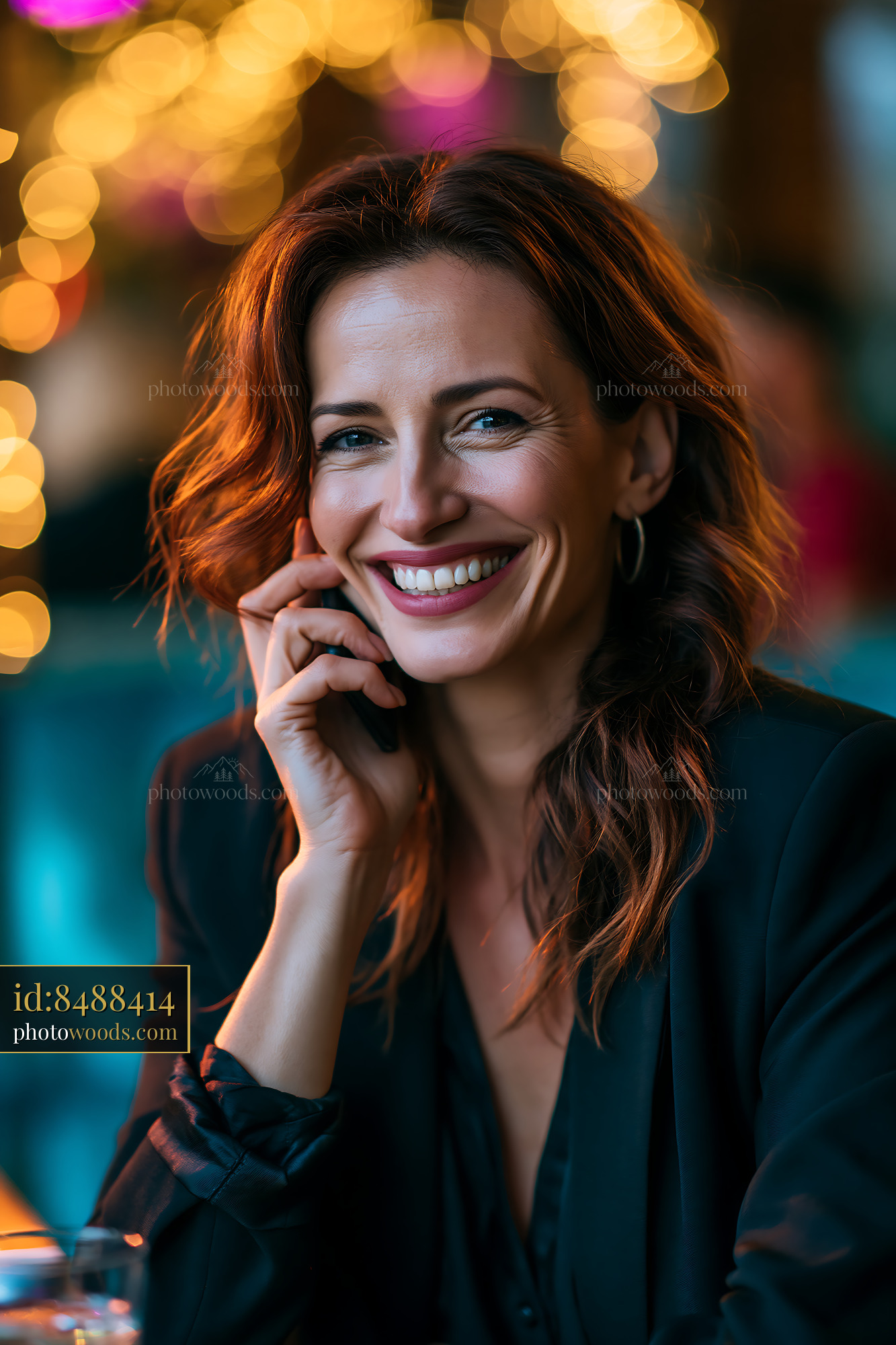 Woman Smiling While Talking on the Phone in Cafe With Lights