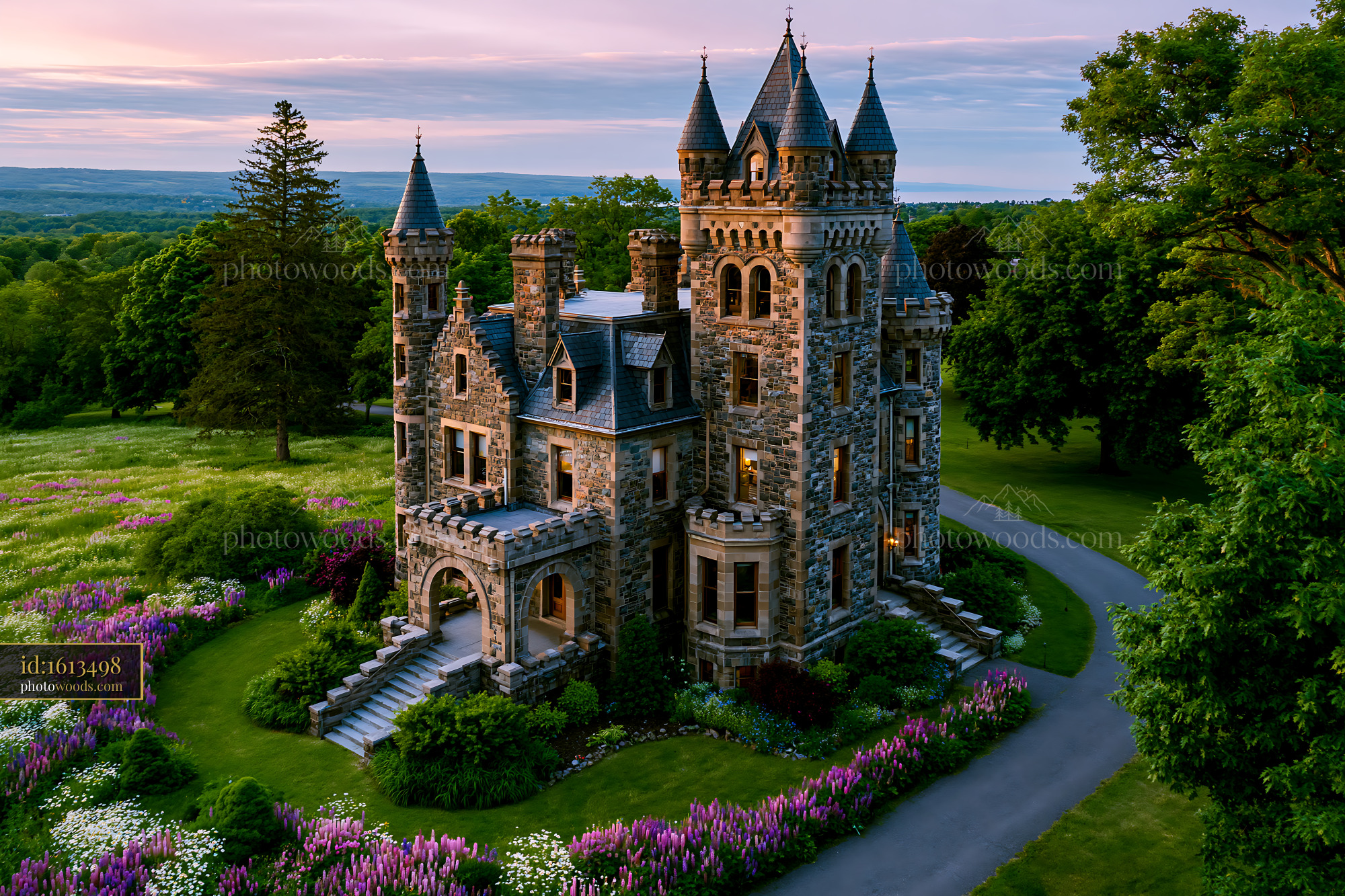 Historic Stone Castle Surrounded by Blooming Flowers at Sunset