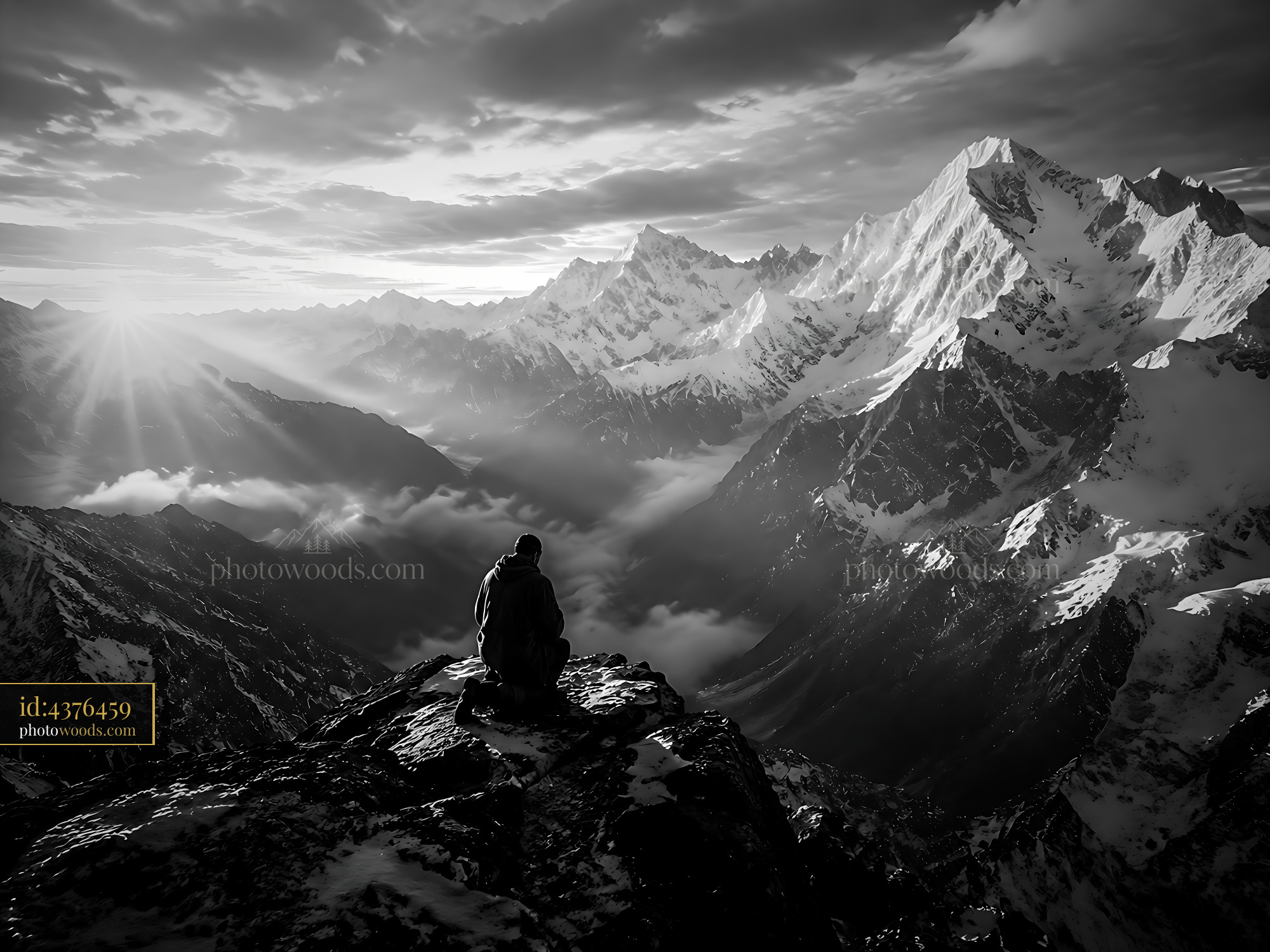 Person Sitting on Mountain Edge Looking Over Valley at Sunset