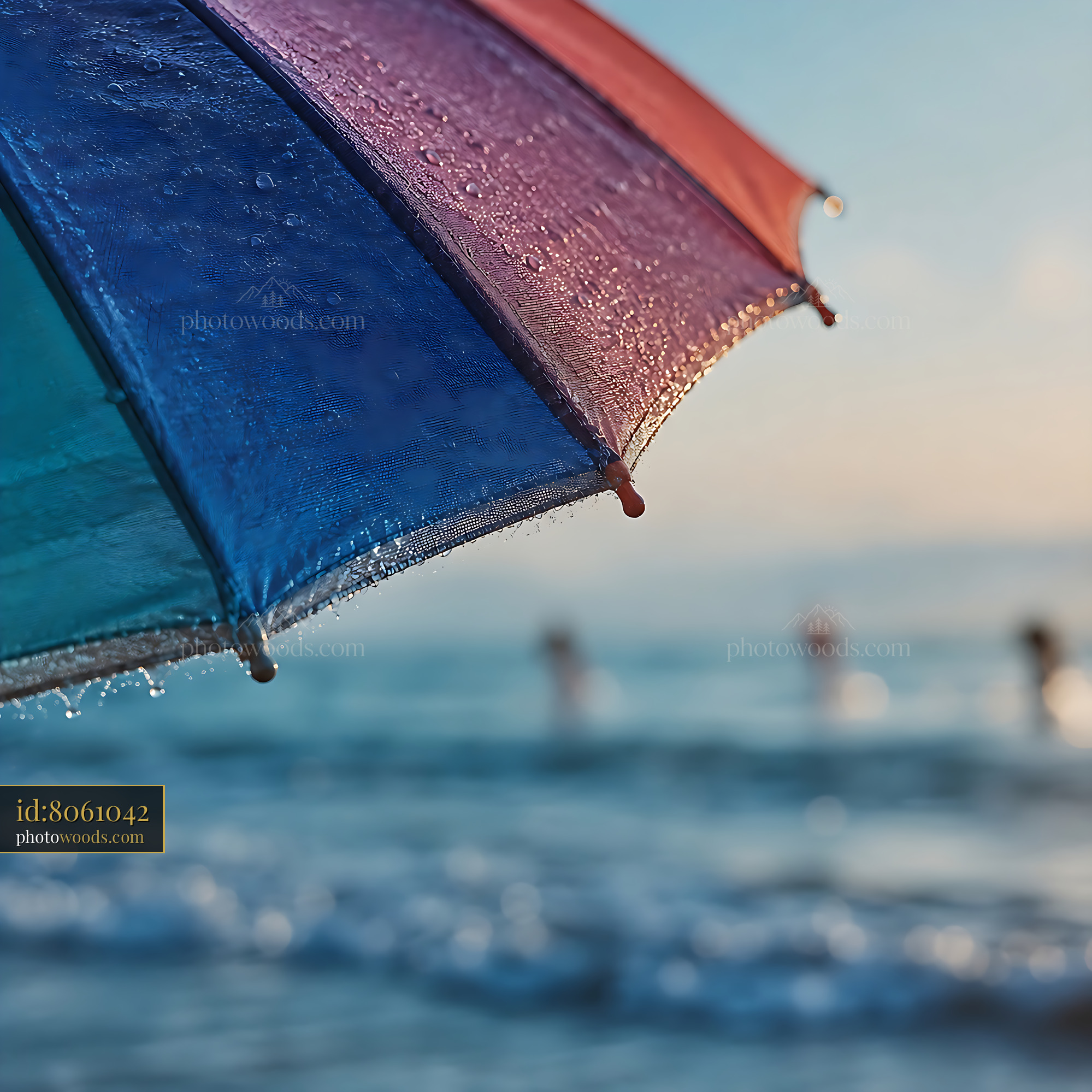 Umbrella Provides Shade on Beach as People Swim in Ocean