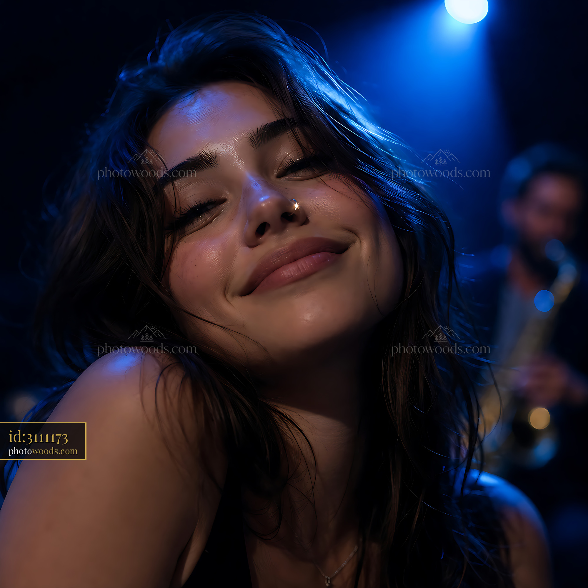 Woman Smiles Under Blue Lights at a Music Event