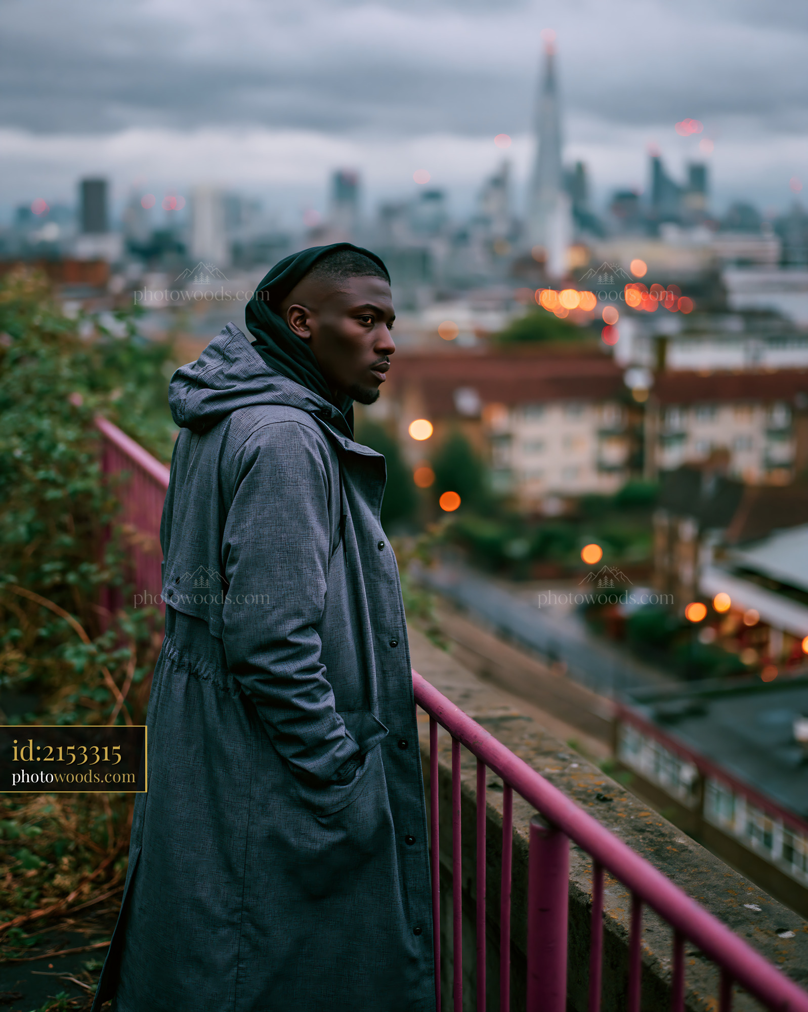 Model in Long Technical Coat Overlooking City Skyline