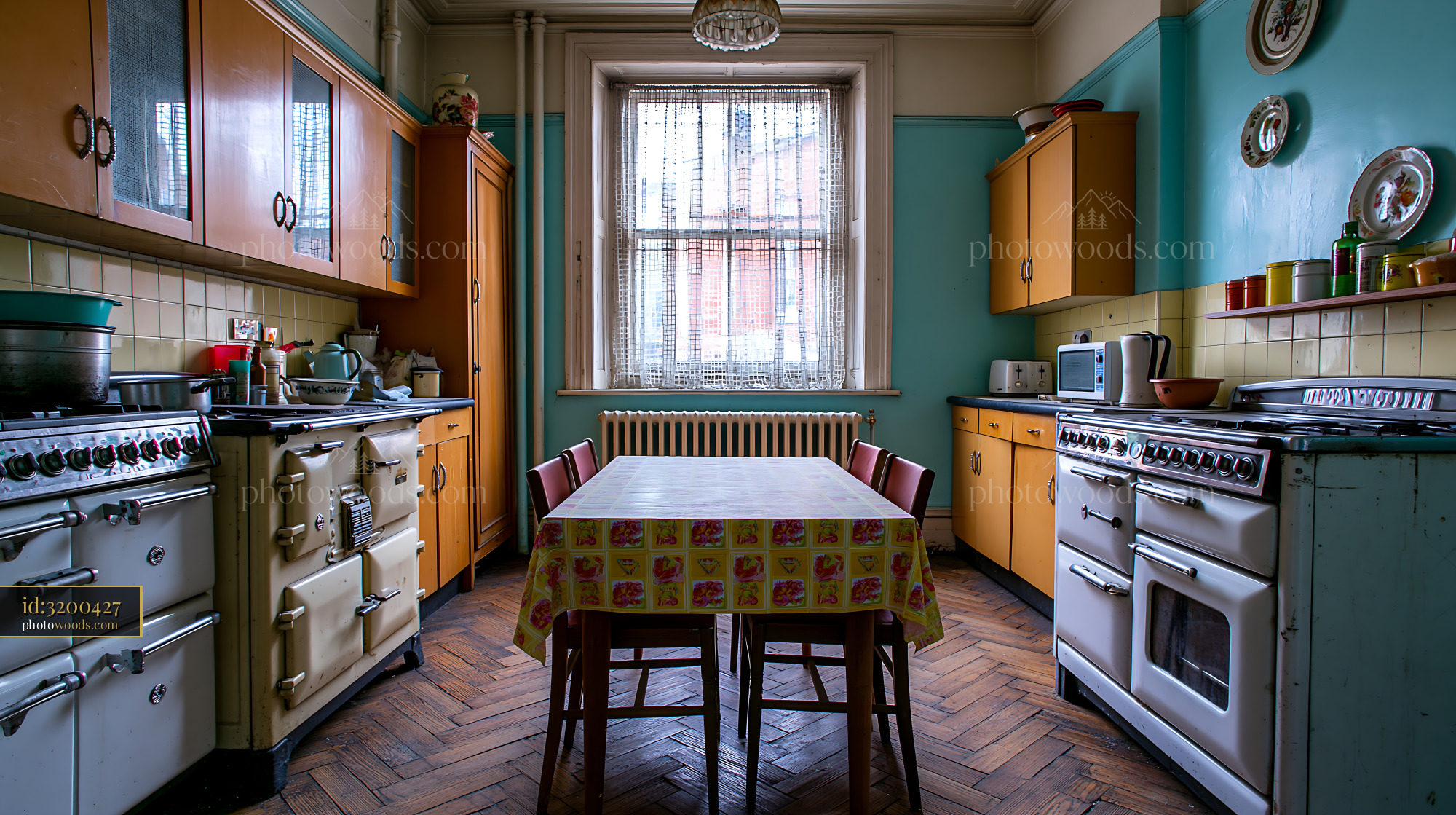 Grimy Communal Kitchen With Four Old Stoves and Wooden Table