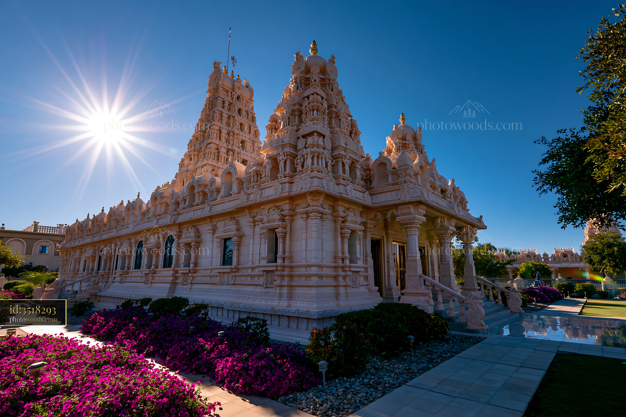 Maha Temple Architecture in Sunlight With Vibrant Flowers
