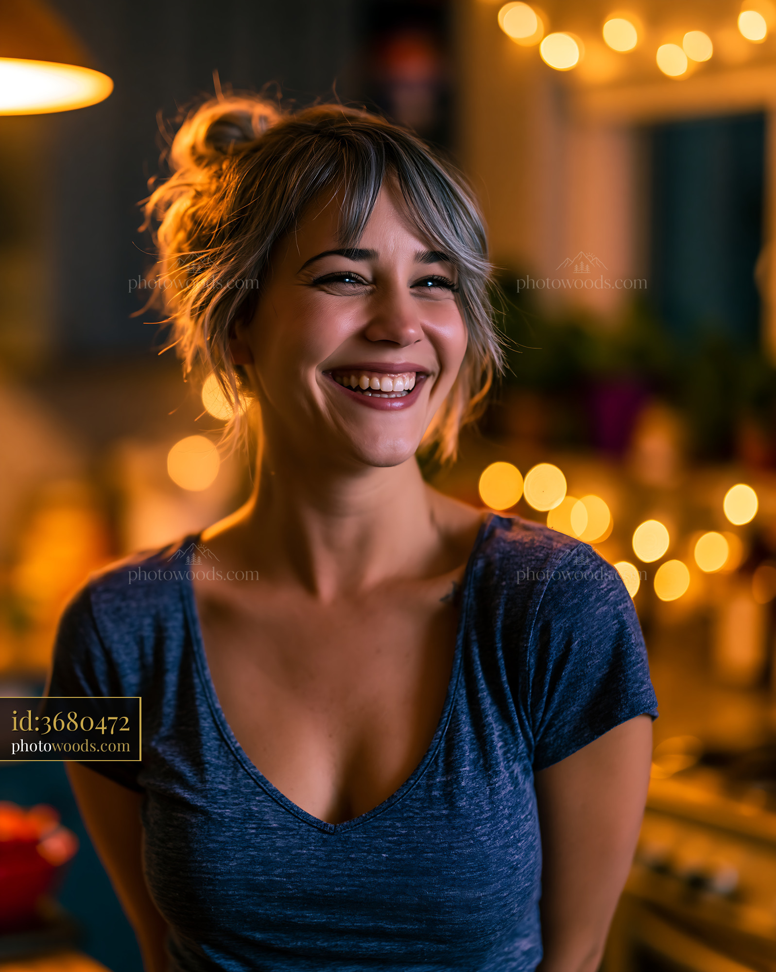 Woman Smiles in Cozy Kitchen With Warm Lights at Evening Time