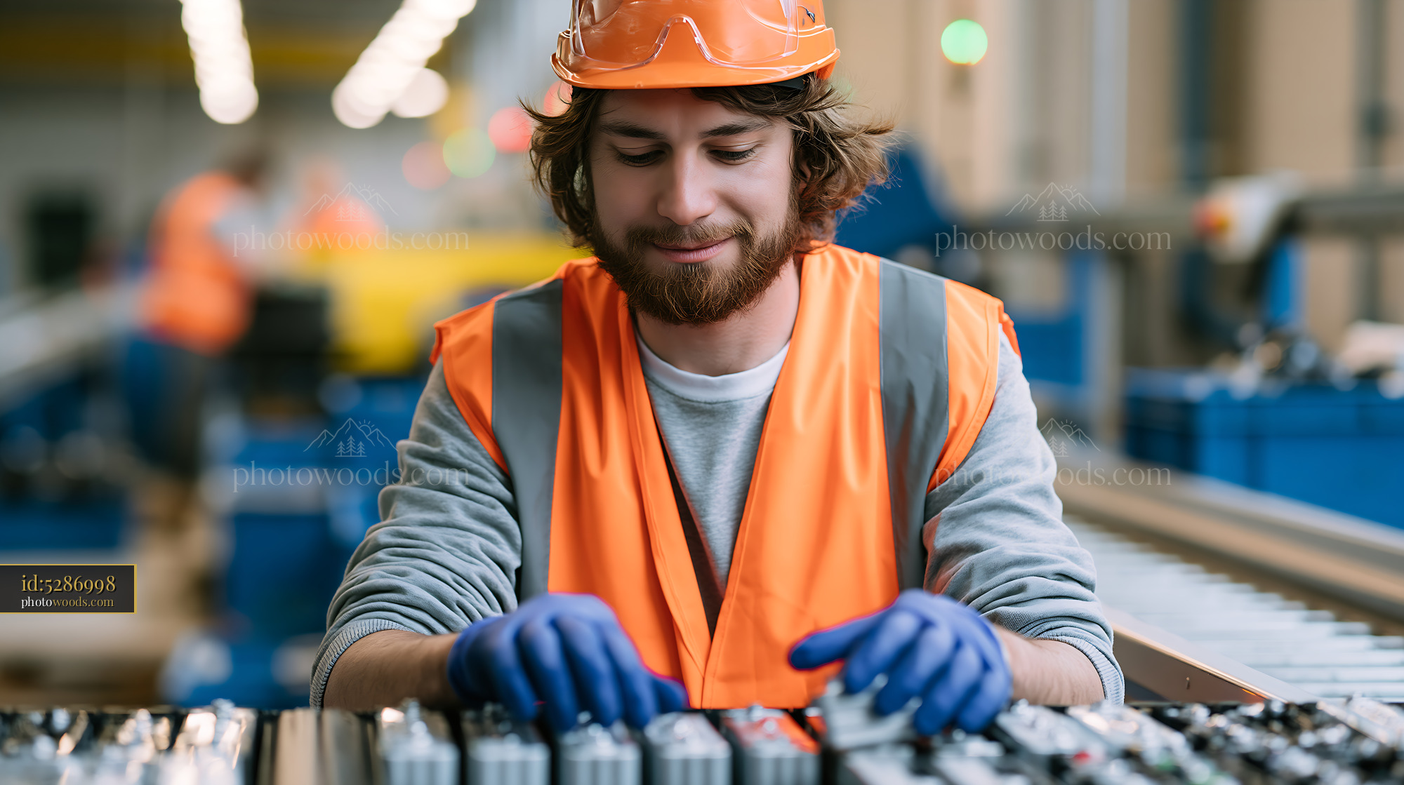 Worker at a Battery Recycling Line Sorting Materials in Factory