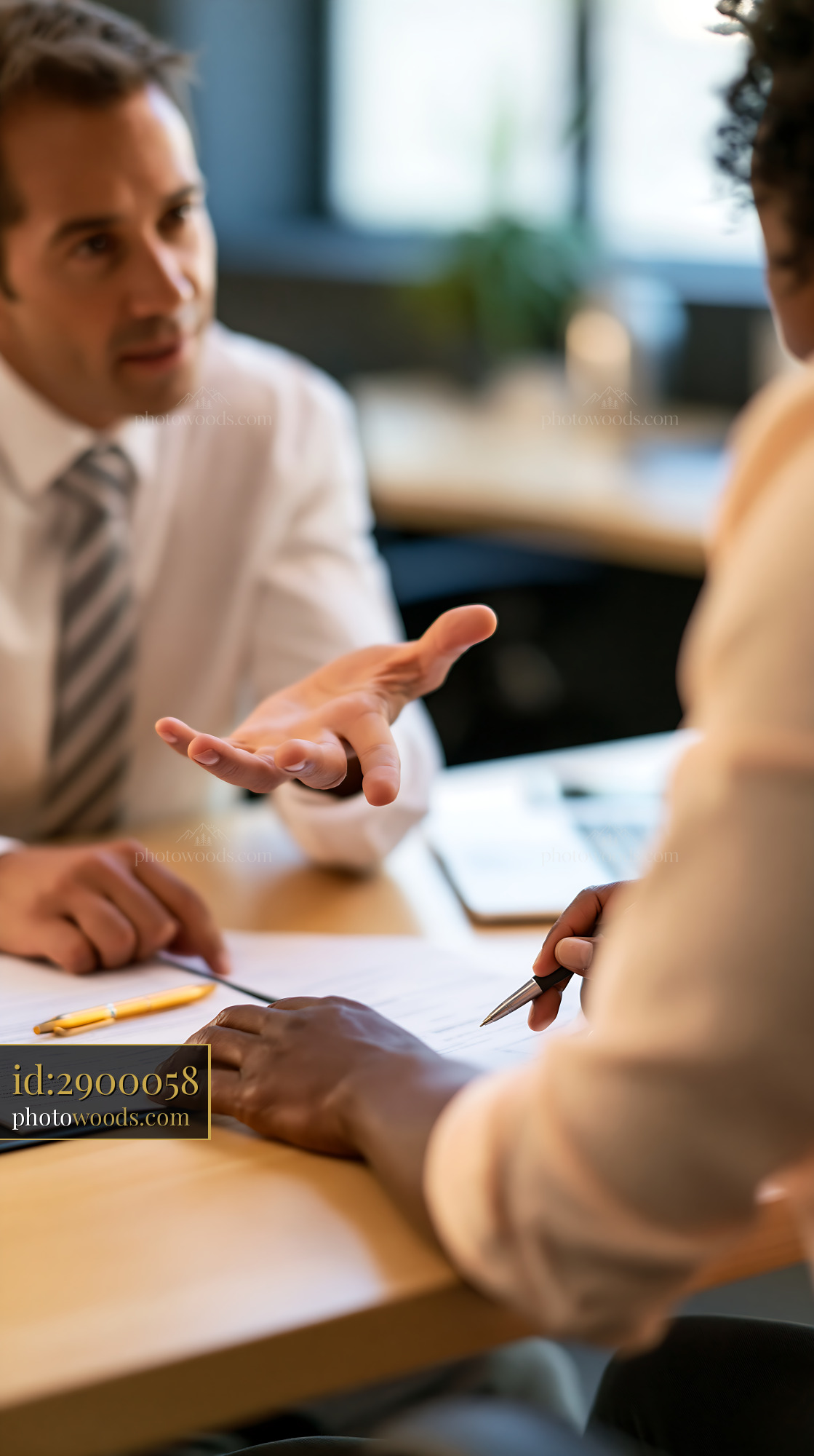 Tax Consultant Explaining Paperwork to a Client in Office Setting