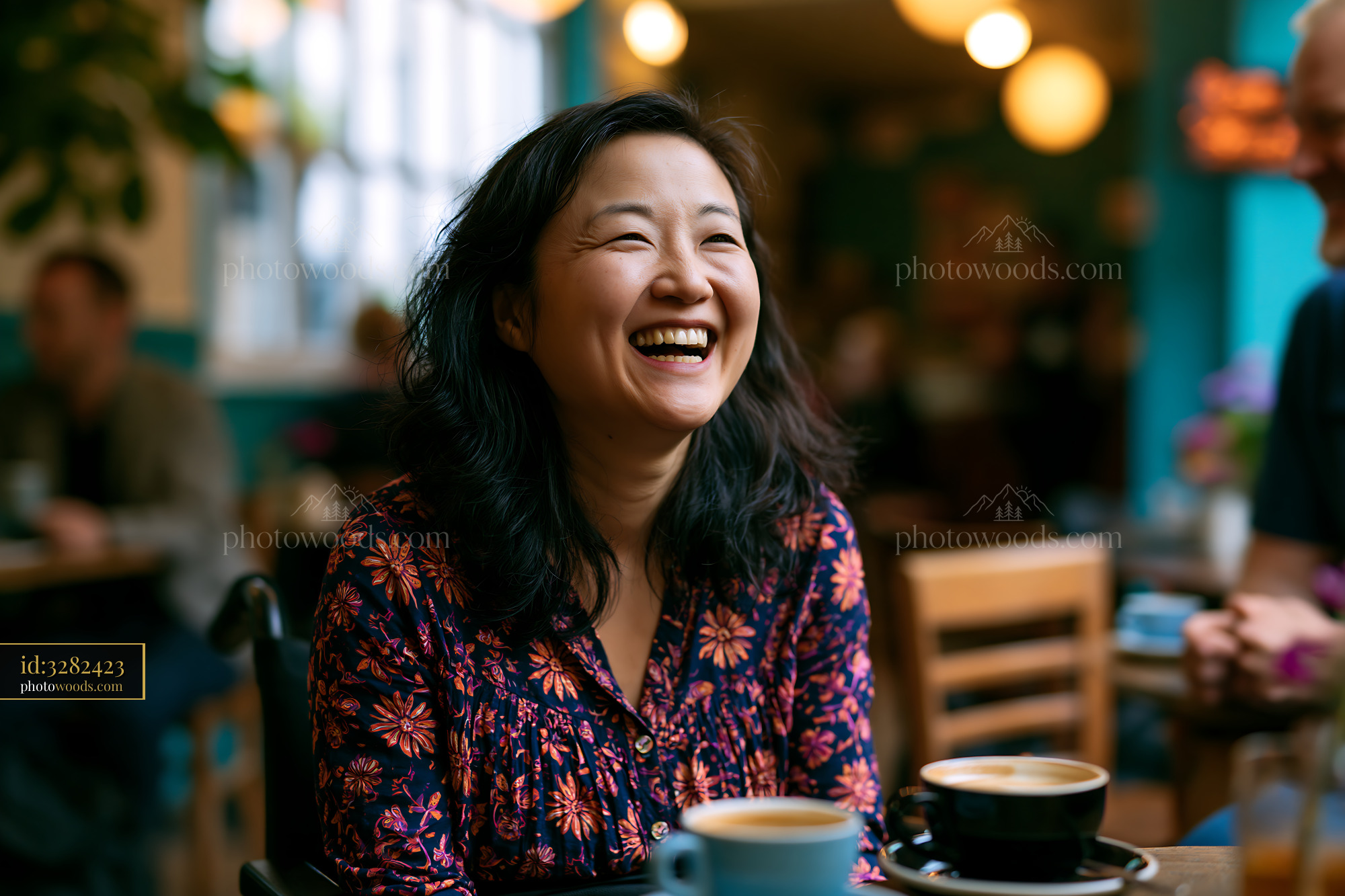 Laughing Woman in Wheelchair Enjoying Coffee at a Cafe