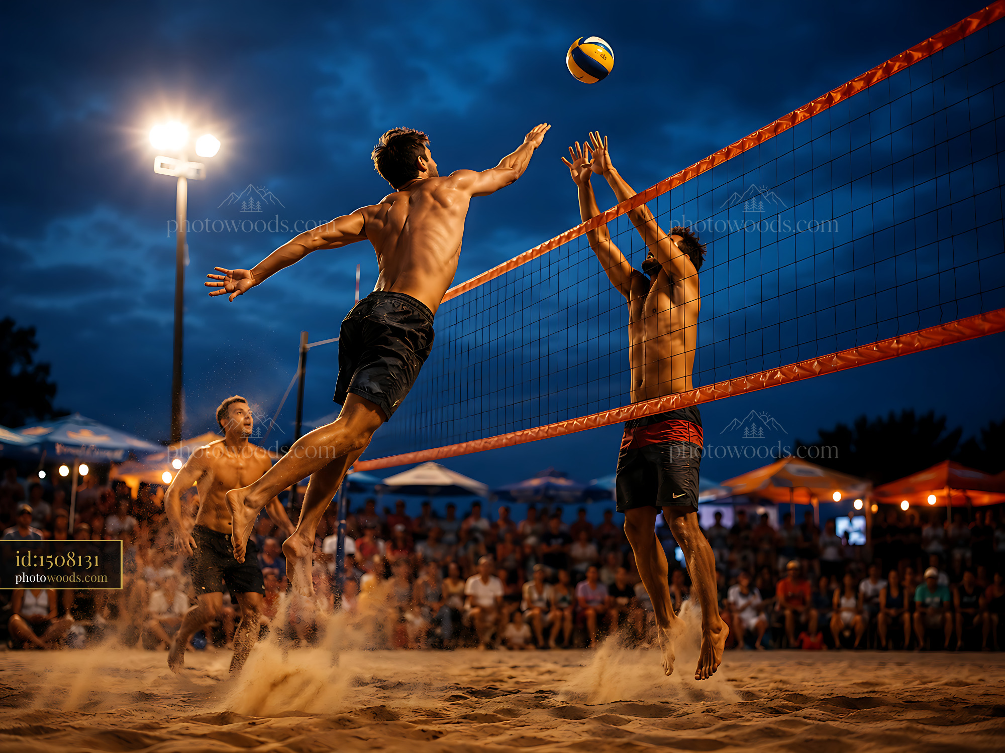 Beach Volleyball Players Competing Under Lights in Evening