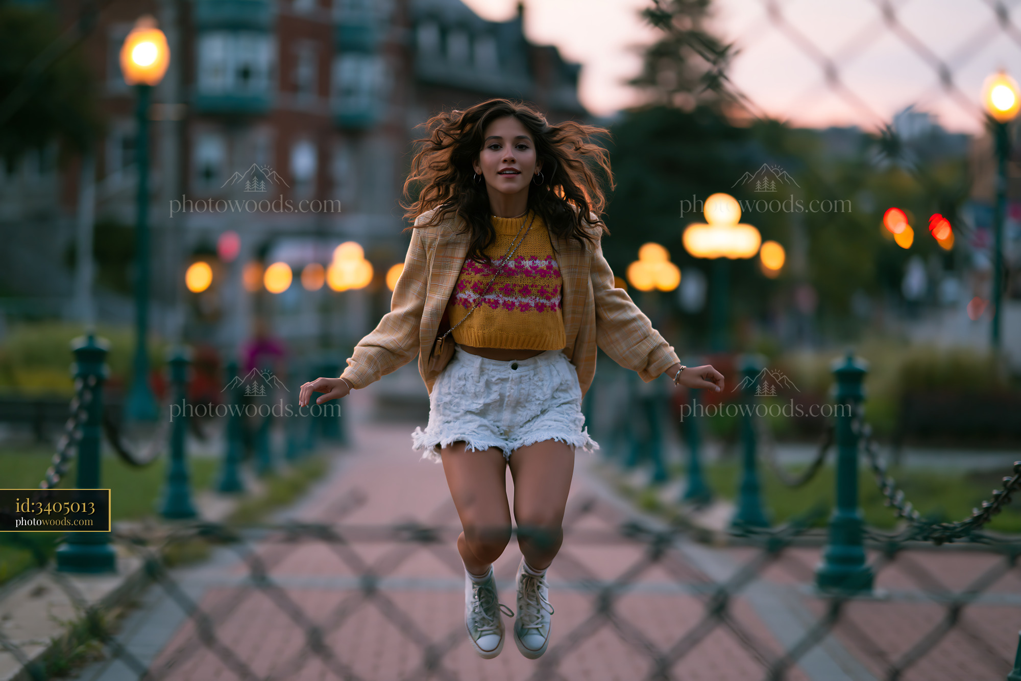 Woman Jumping in Oversized Blazer and Bike Shorts at Sunset