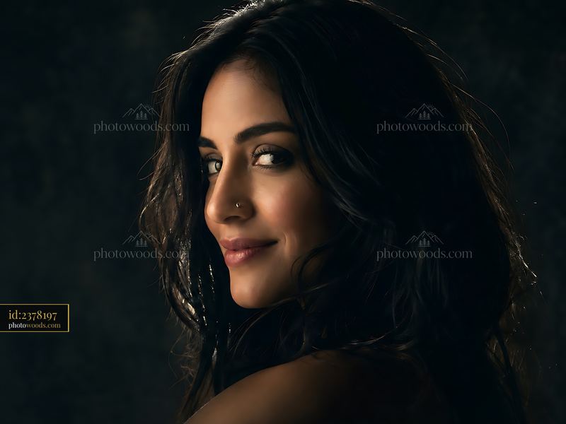 Woman With Dark Hair Looking Over Her Shoulder With a Smile