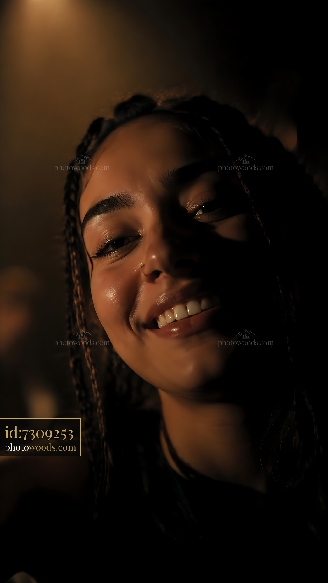 Woman Smiling Under Warm Light in Indoor Gathering Space