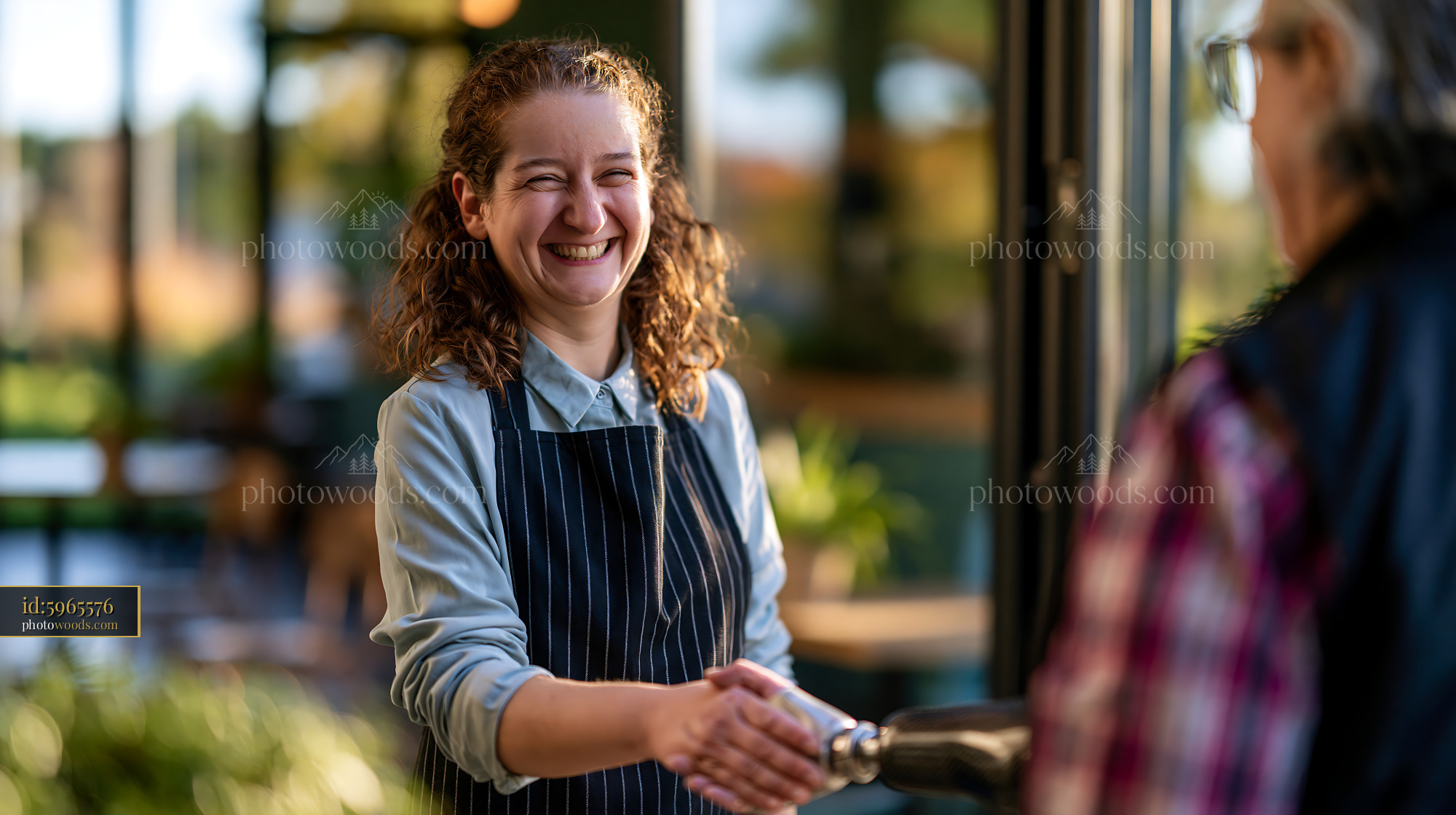 Smiling Businesswoman Shakes Hands at a Cafe