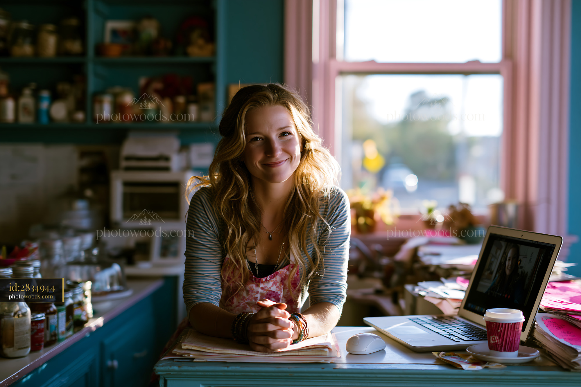 Small Business Owner Smiling in Her Shop With a Laptop