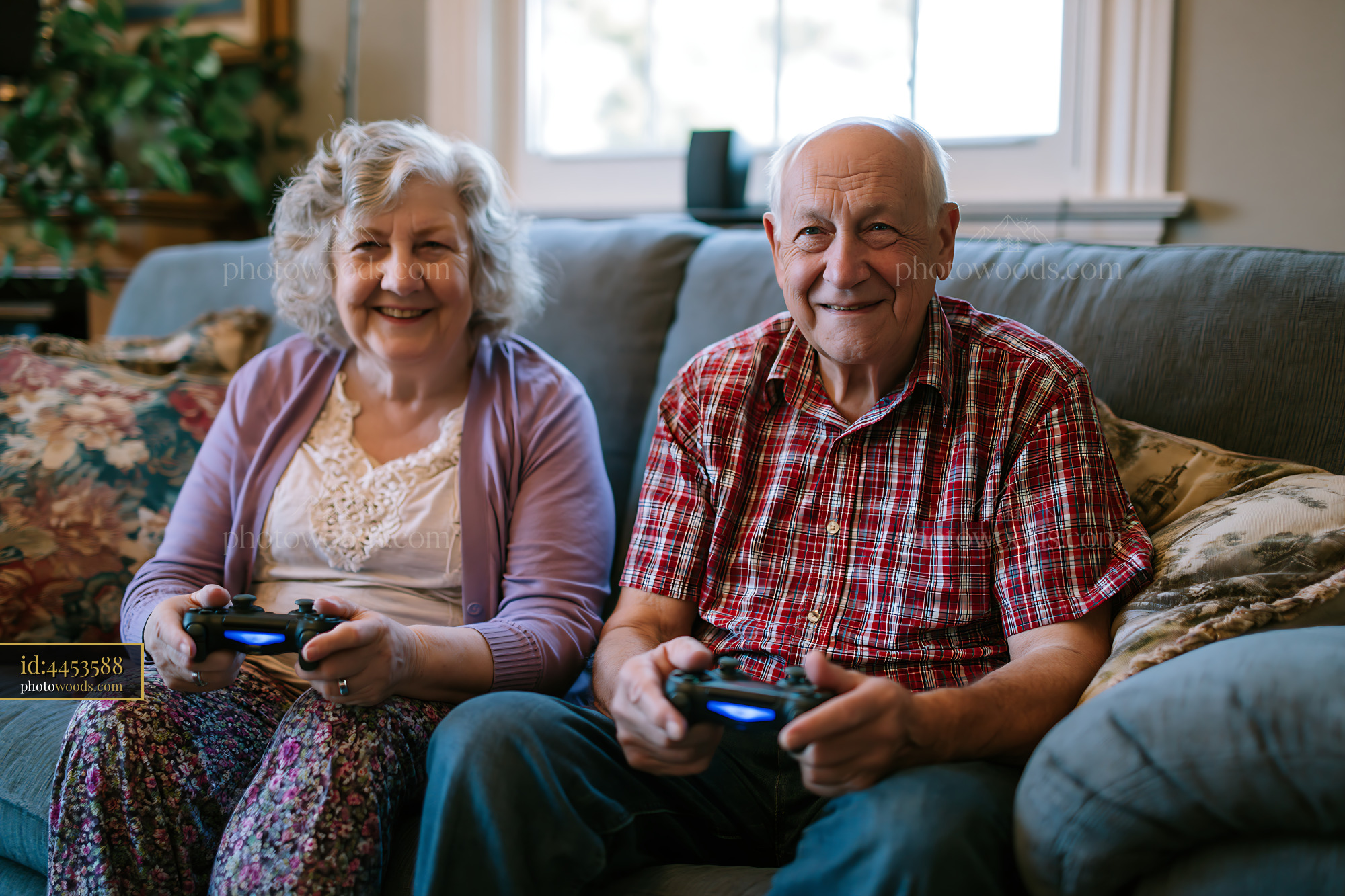Elderly Couple Playing Video Games on a Couch in Their Home