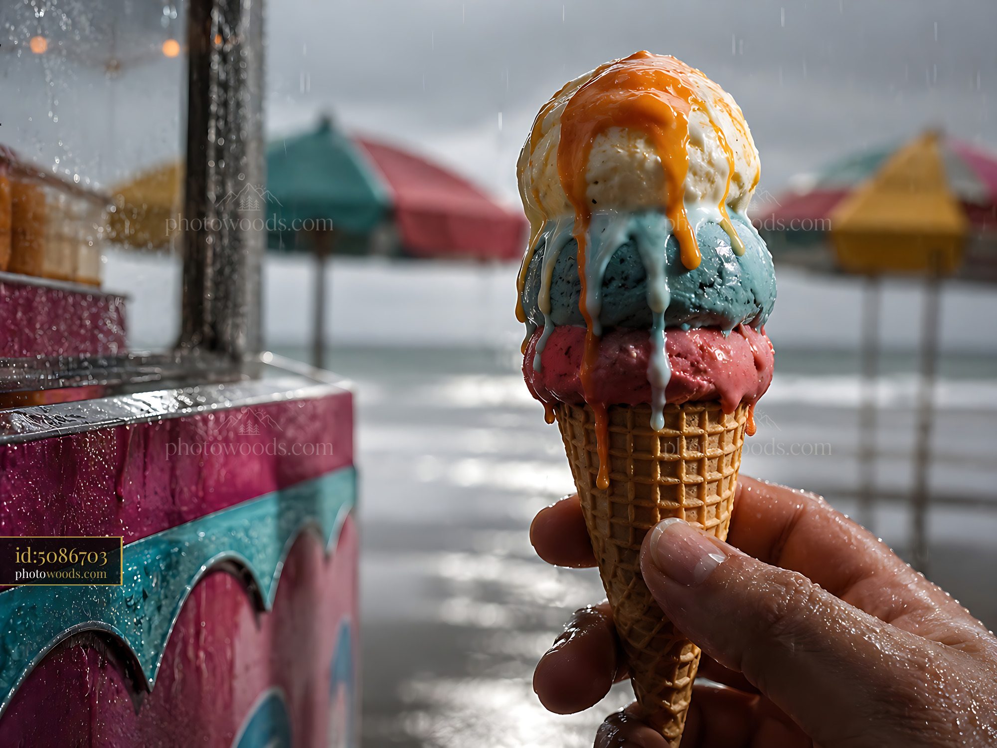 Ice Cream Cone Held by a Person Under Umbrellas at the Beach