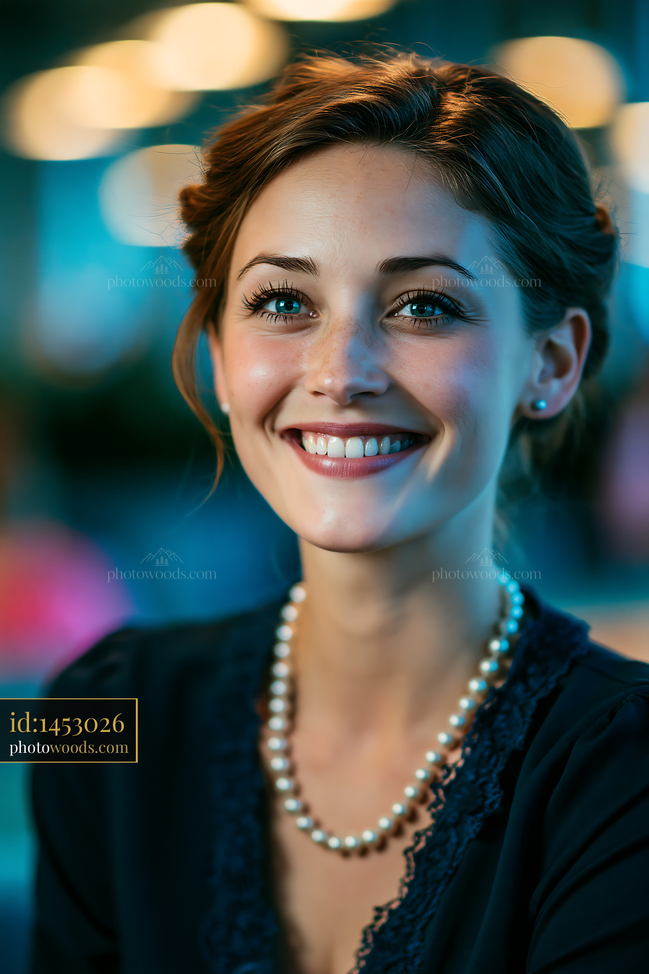 Woman Smiling Indoors Under Warm Light With Pearls Around Her Neck