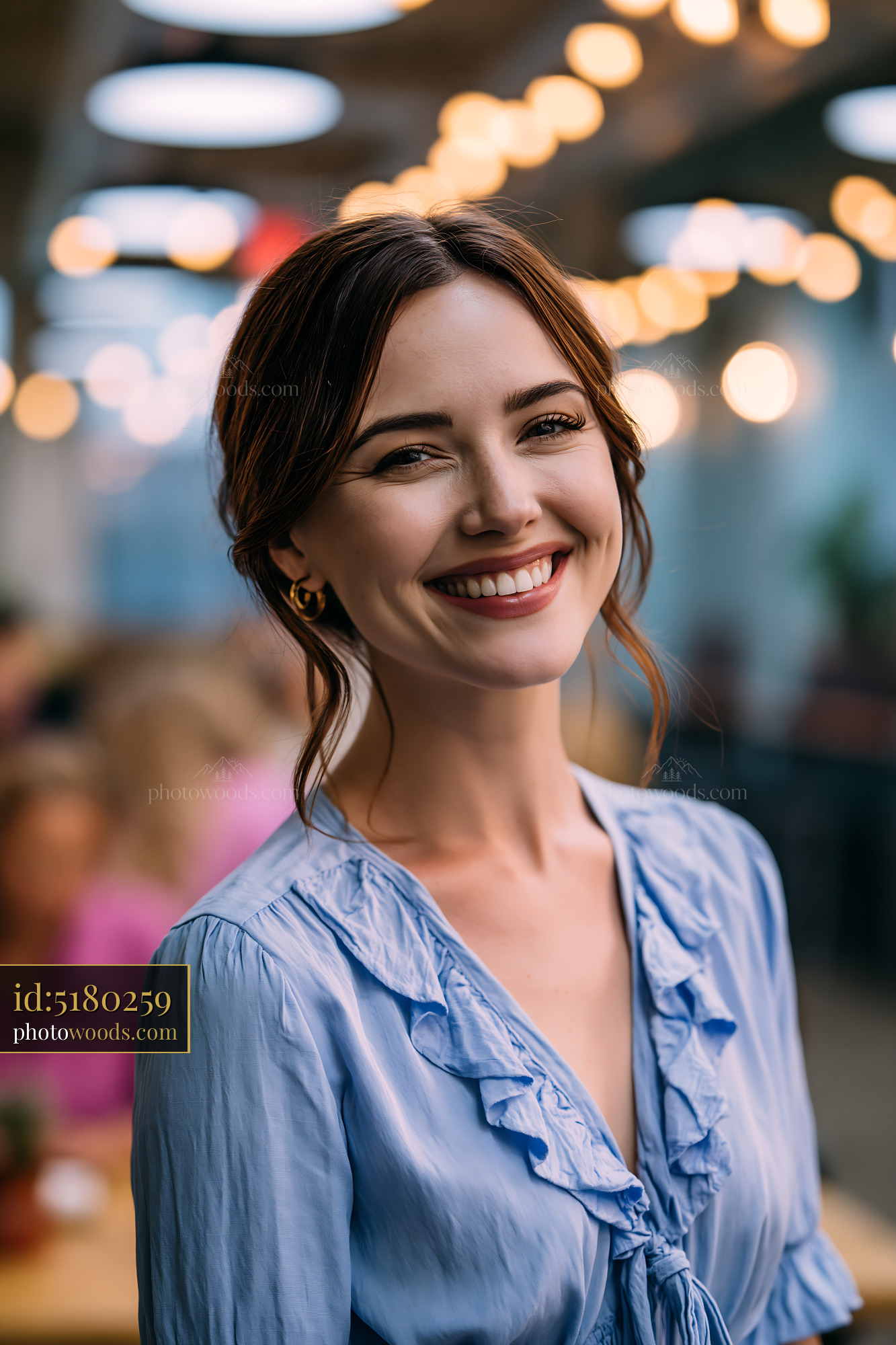 Woman Smiles Indoors During Gathering With Friends in Cafe