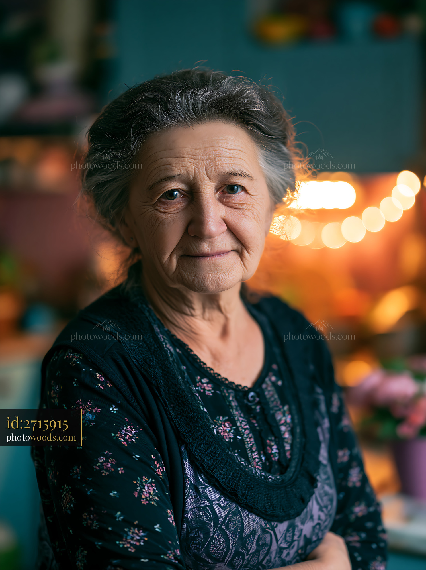 Senior Woman Stands in a Room With Warm Light in the Background