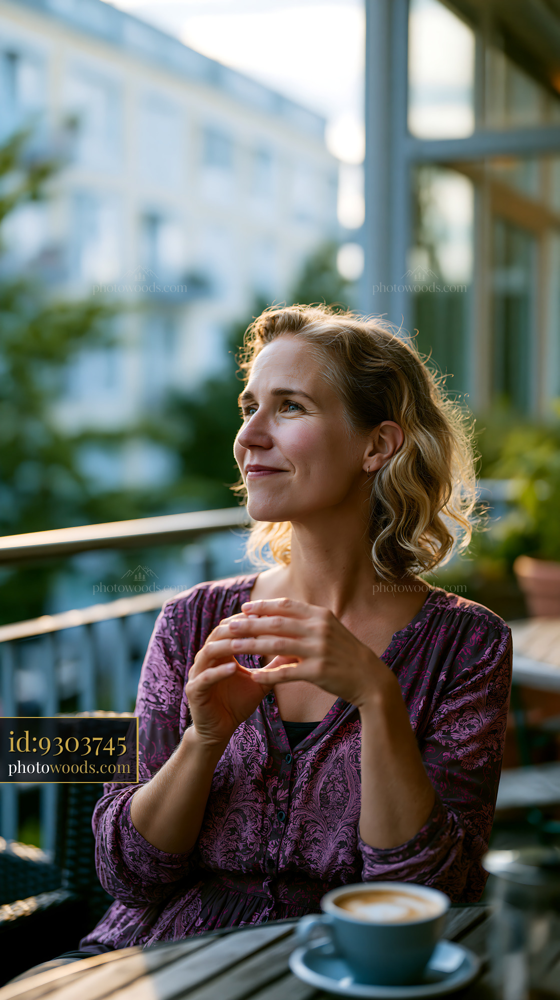 Woman Enjoying a Coffee in a Café During Golden Hour