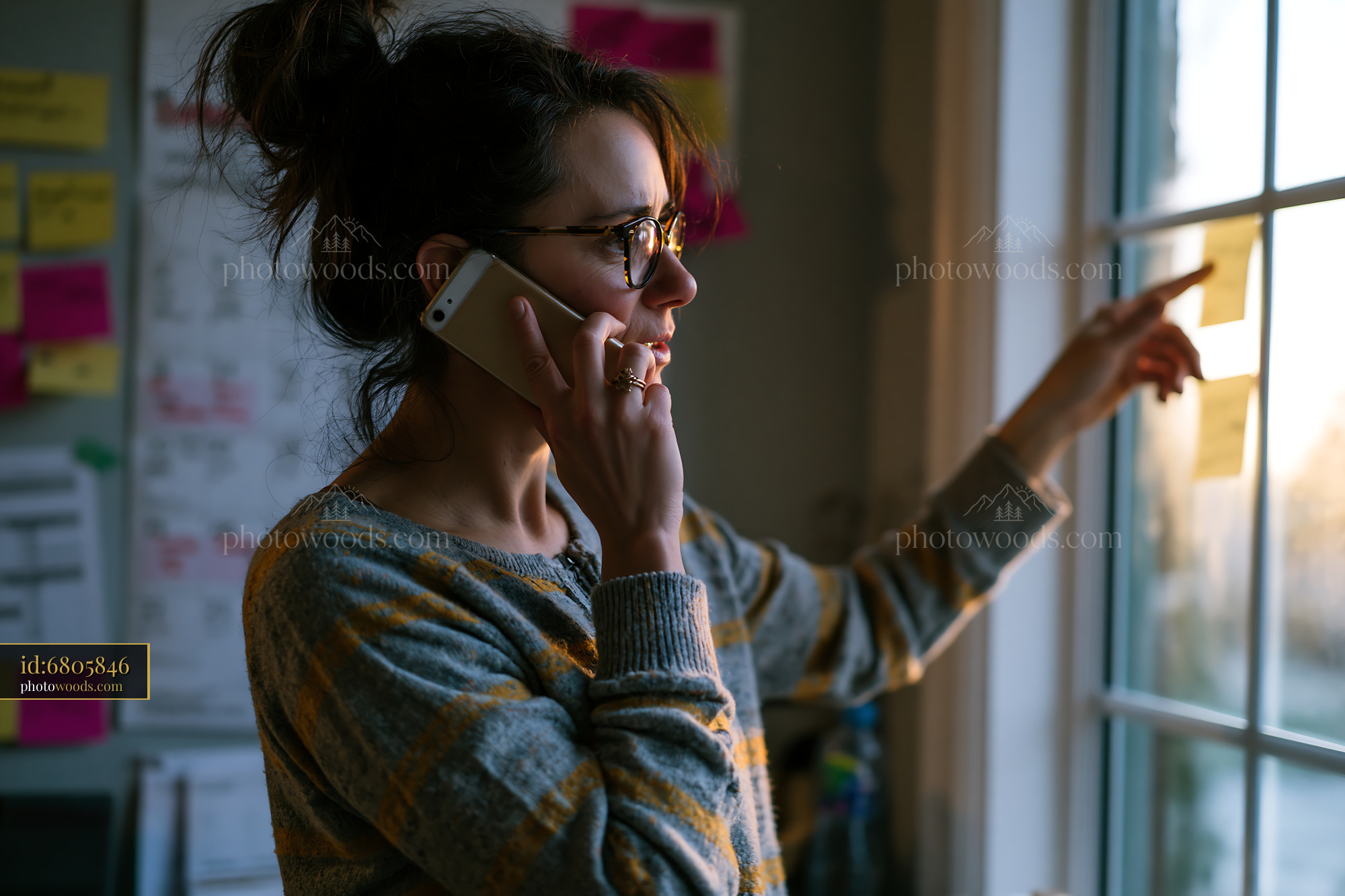 Daughter Organizing Care on Phone Near Window During Afternoon