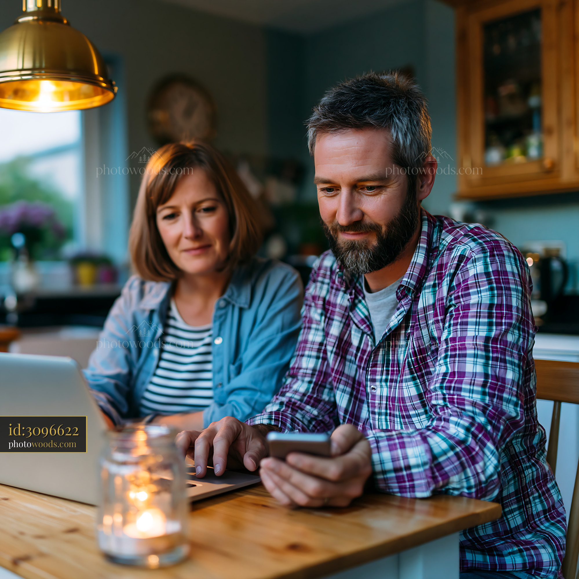 Couple Coordinating Shared Calendar at Home in Evening Light