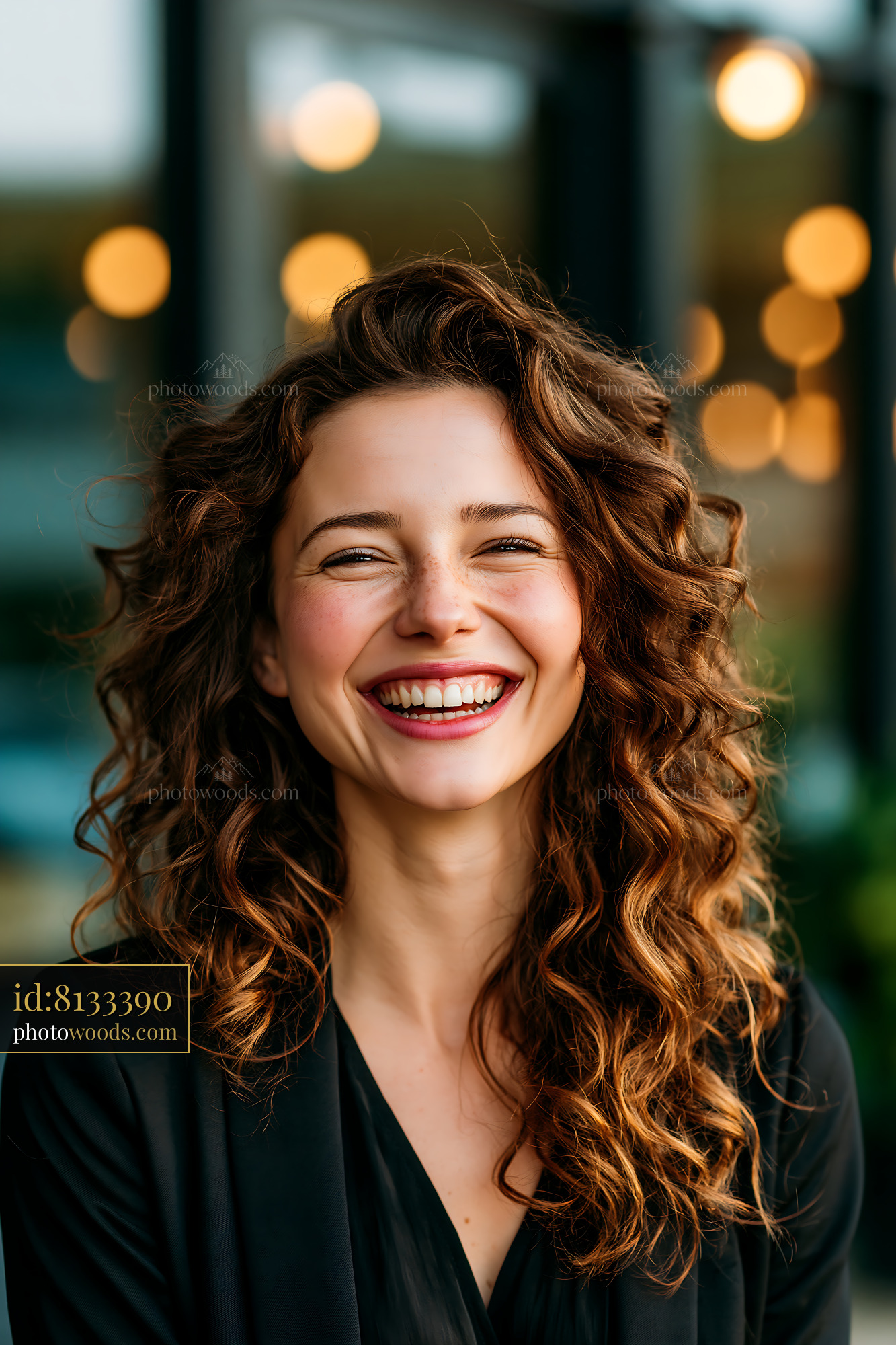 Woman Smiles With Curly Hair in a Cafe During the Day