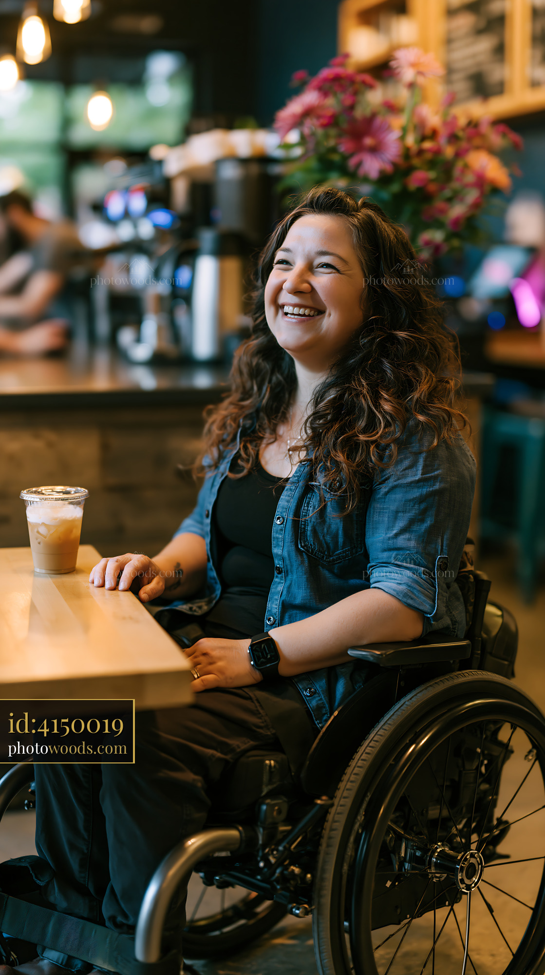 Laughing Woman in Wheelchair Enjoying Drink in Coffee Shop