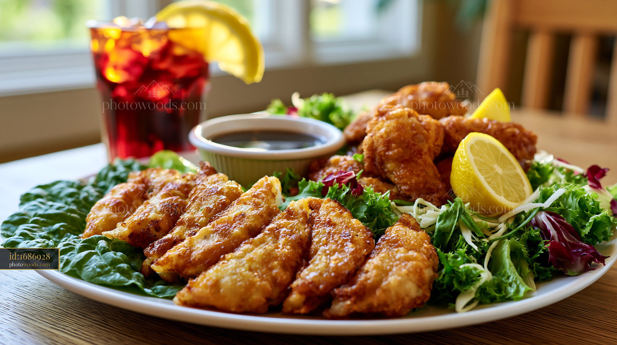 Gyoza on a Plate With Crispy Wings and Fresh Greens