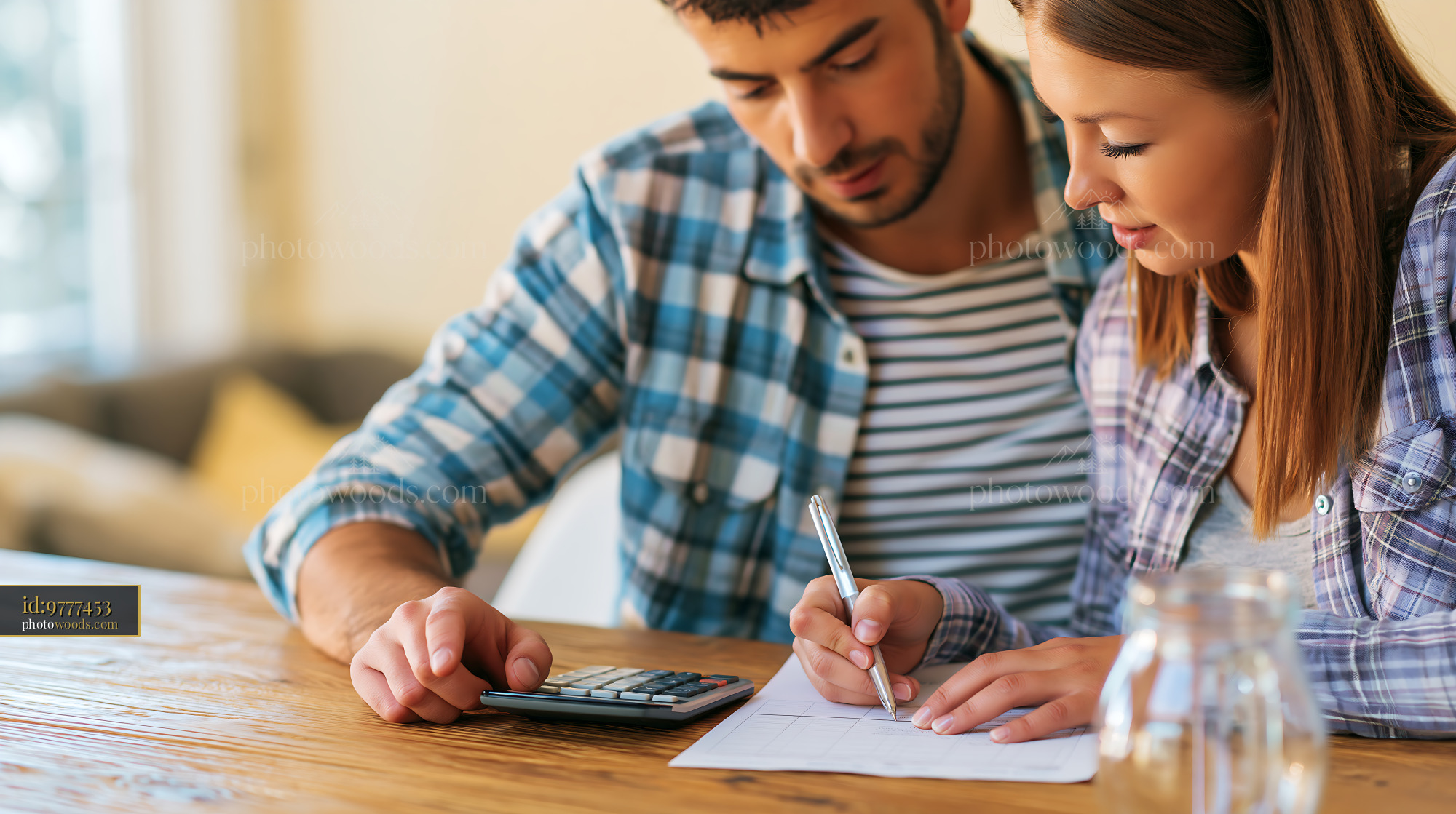 Young Couple Planning Monthly Budget at Home