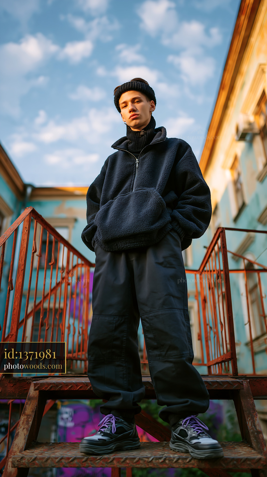 Young Man in Knitted Balaclava Standing on Stairs, City Setting