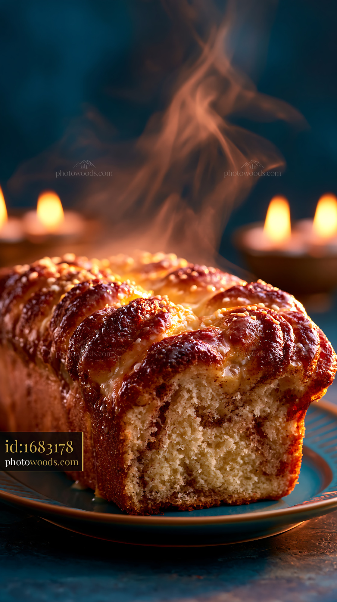 Cinnamon Babka Loaf With Steam on a Plate and Candles