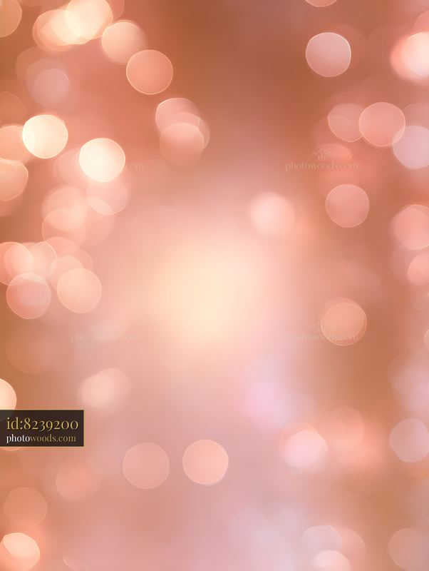 Soft peach bokeh light background with glowing circles
