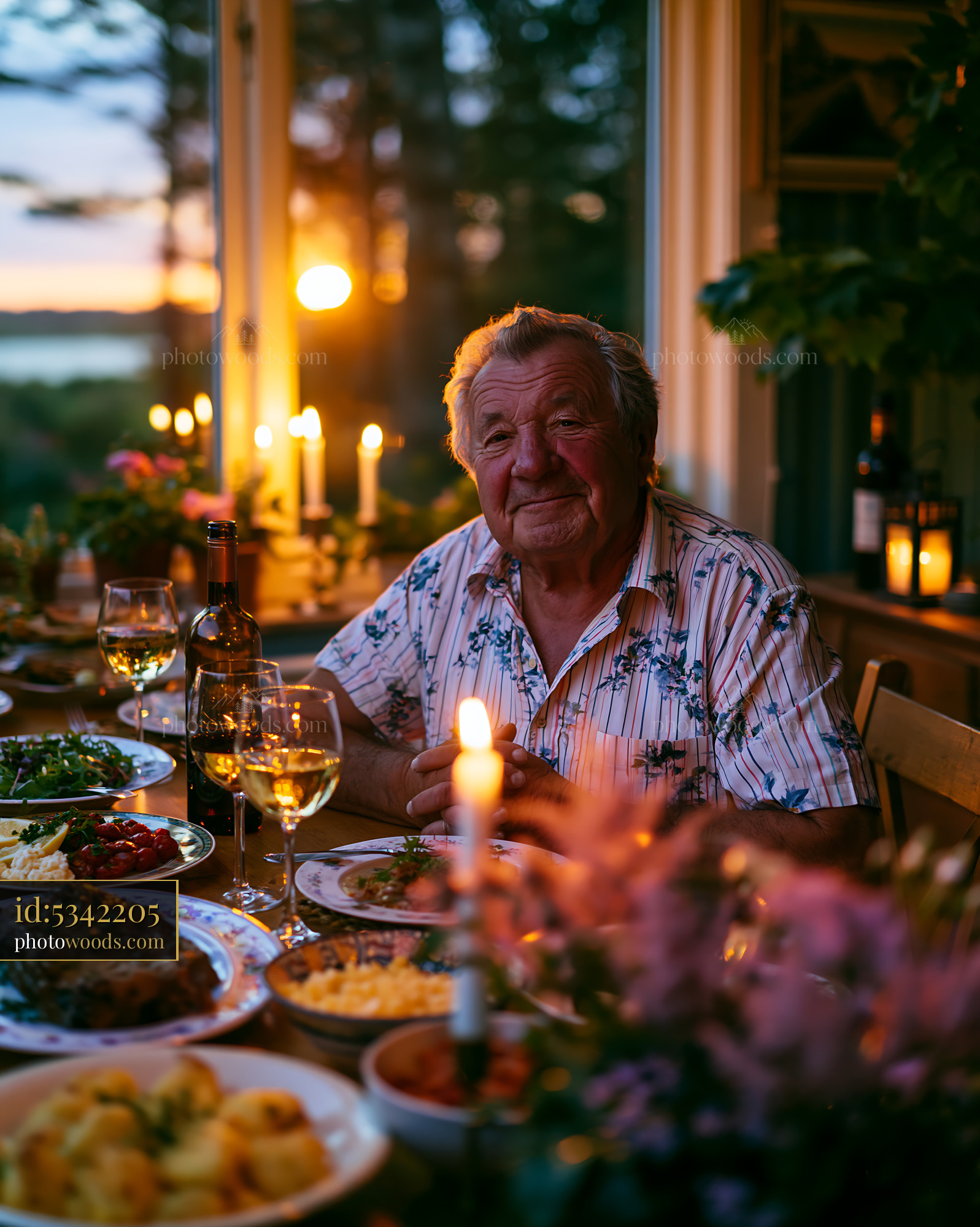 Senior Man Enjoying Dinner at Sunset With Candles and Wine