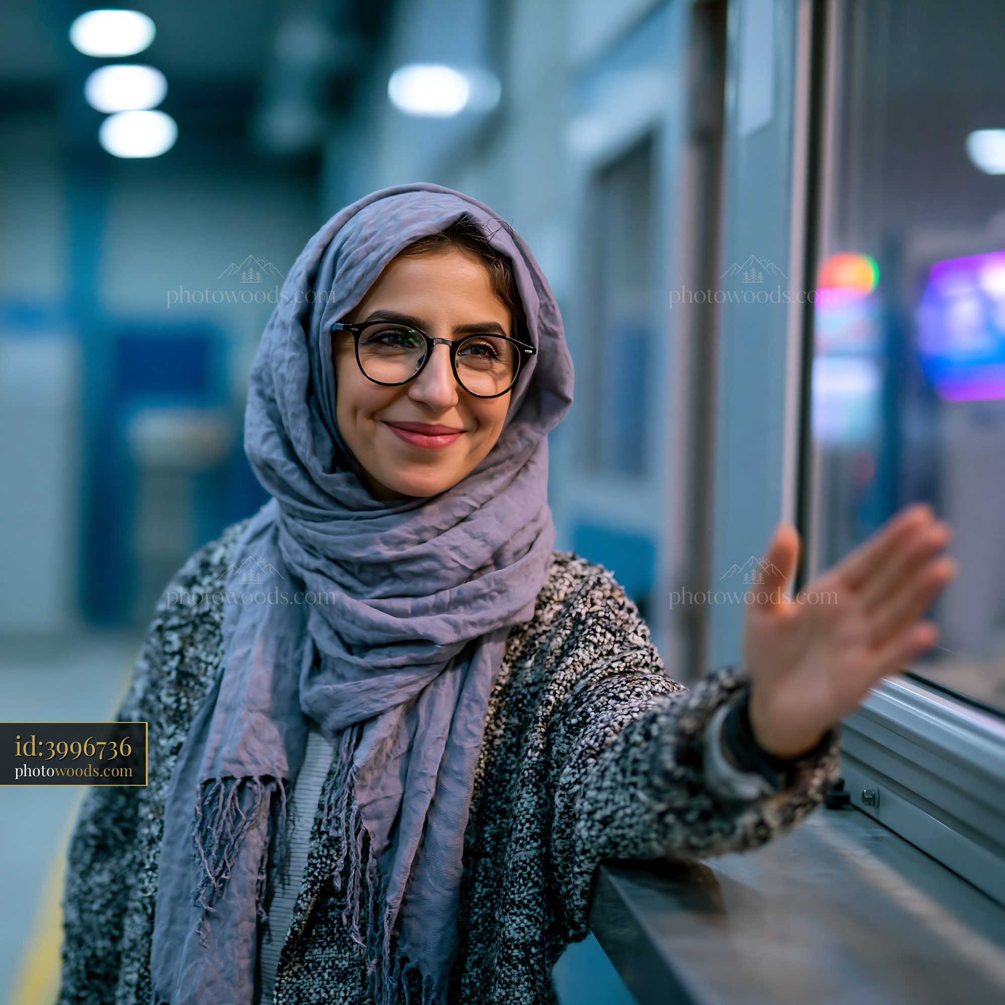 Female Engineer in Hijab Greeting in a Modern Office Setting