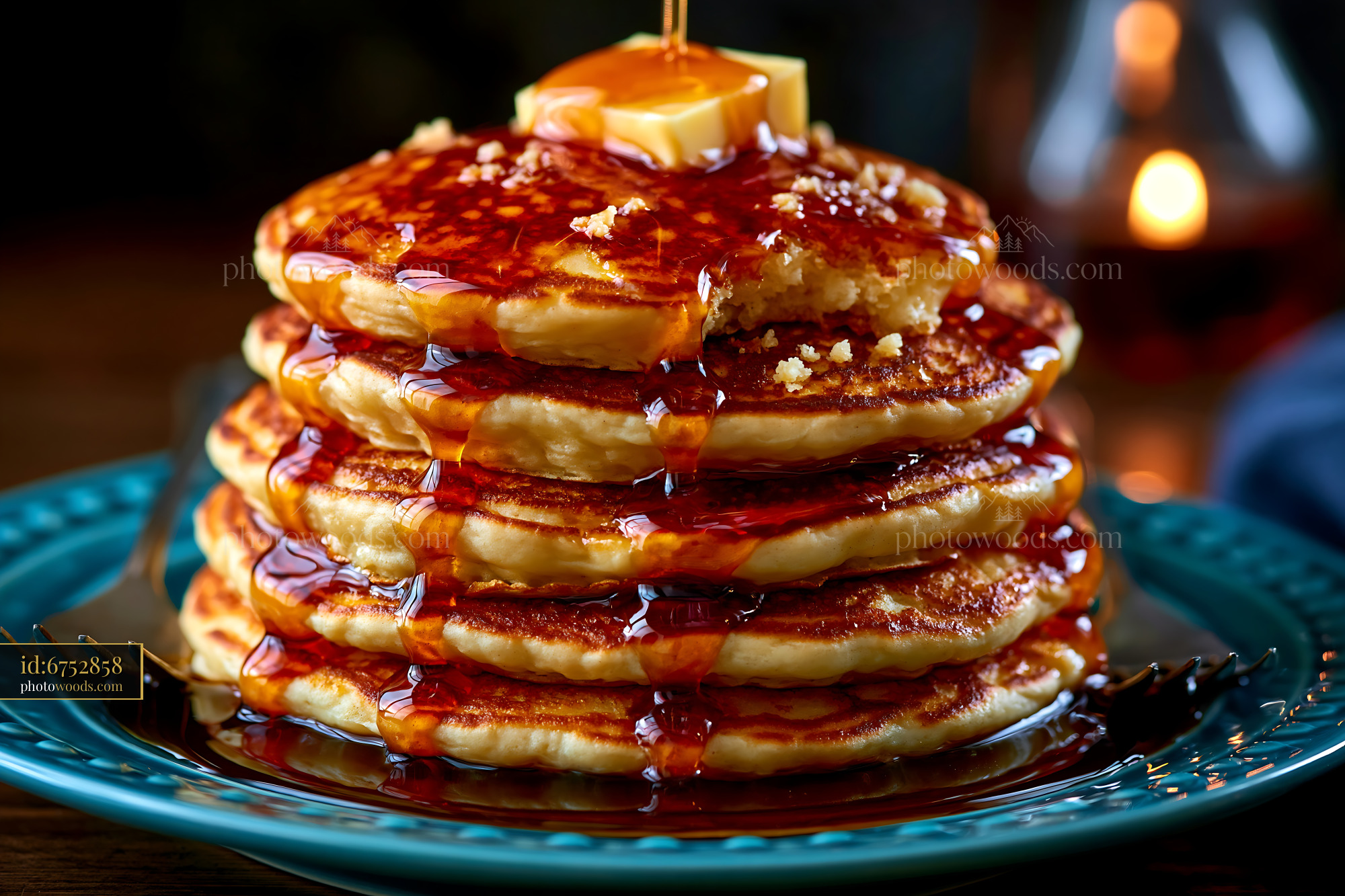 Fluffy Pancakes Stacked High With Syrup and Butter