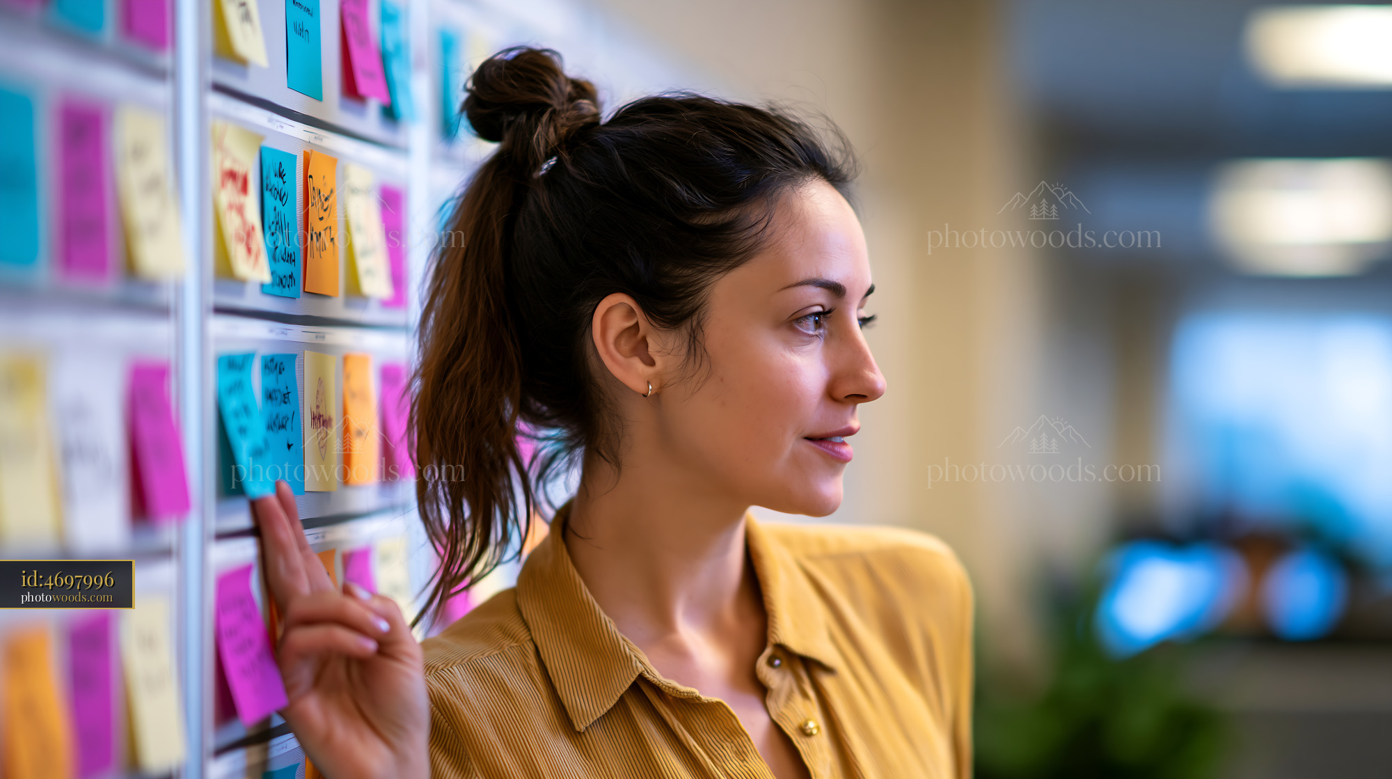 Manager Coordinating Projects With Sticky Notes in Office